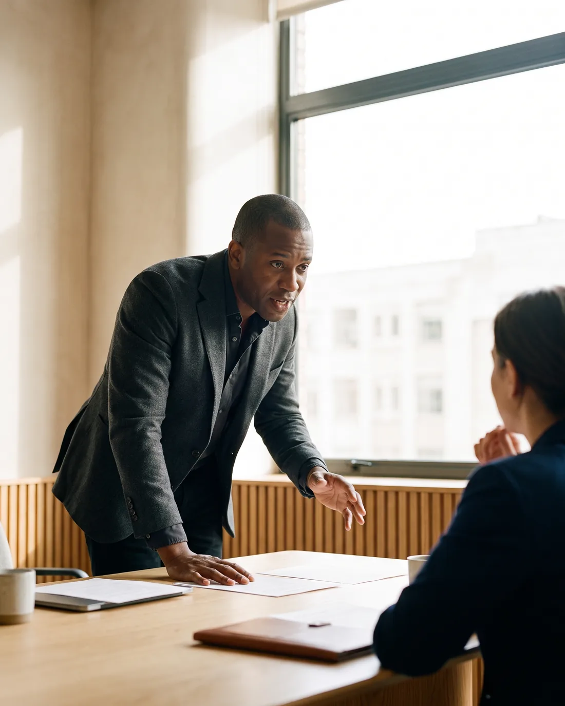 A senior CFO reviewing the work in a calm Seattle boardroom